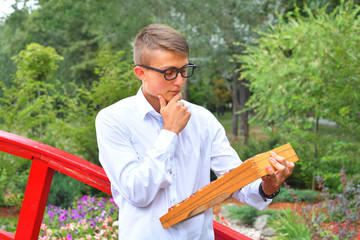Boy with large abacus. Thoughtful schoolboy using a maths abacus calculation