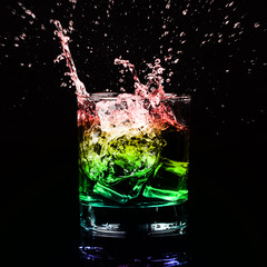 Isolated shot of whiskey with splash on black background