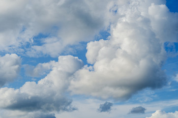 large fluffy clouds on a background of blue sky