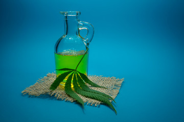 Cannabis leaf and glass decanter on hessian