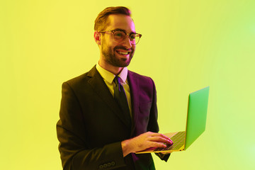 Optimistic pleased positive happy young business man posing isolated over light green background...