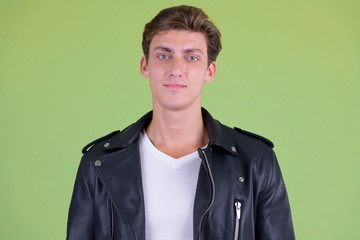 Face of young handsome rebellious man looking at camera