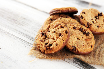 Chocolate cookies on wooden table. Chocolate chip cookies shot on wooden white table
