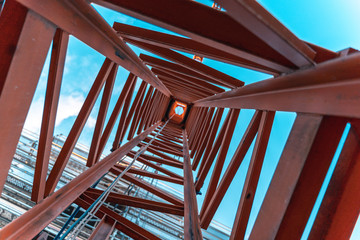 looking up inside a construction crane from the ground.