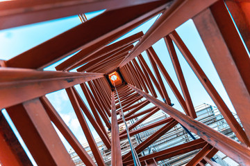 looking up inside a construction crane from the ground.