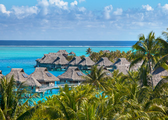 French Polynesia. Over water bungalows and palm trees..