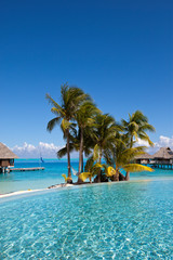 View of the sandy beach with palm trees and pool, Bora Bora, French Polynesia