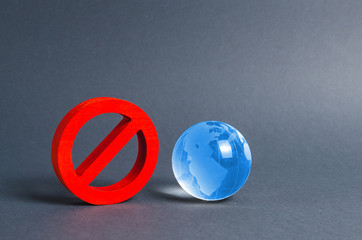 Red prohibition symbol NO and planet earth glass ball. Prohibitions, obstacles and censorship,...