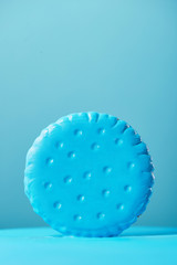 cookie in blue paint conceptual photo