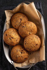 Cookies with chocolate on baking paper. Top view.