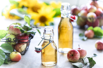 Apple vinegar. Bottle of apple organic vinegar or cider on wooden background. Healthy organic food.