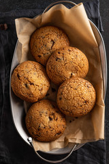 Cookies with chocolate on baking paper. Top view.