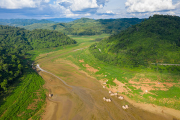 landscape aerial  view valley with bamboo raft on ground and  mountain green natural forest with blue sky background