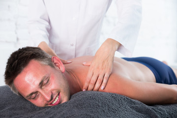Fototapeta na wymiar Relaxing massage for man in spa