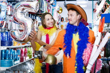 Man with girlfriend trying on cowboy hat and smiling