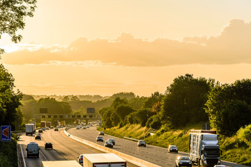 busy traffic on uk motorway road overhead view at sunset