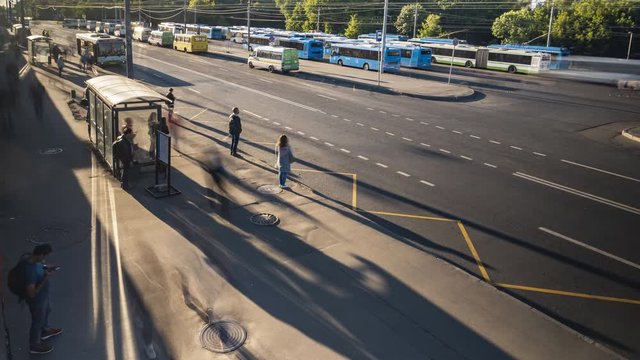 passengers waiting and boarding buses at the bus terminal, time lapse