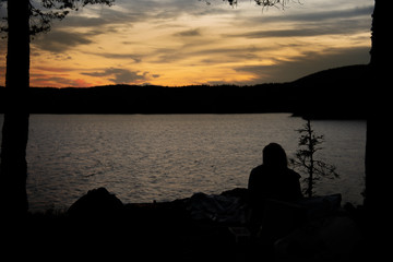 Naklejka na ściany i meble Silhouette at sunset by the lake