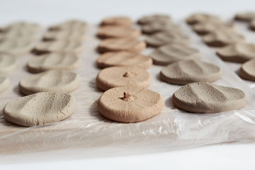 Fototapeta na wymiar clay samplers dry. Spanish stone masses in the form of round pellets for testing glazes