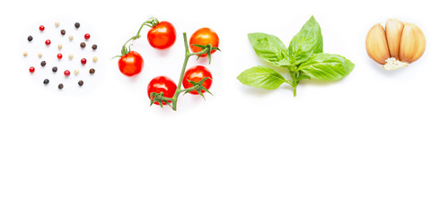 Different type of peppercorns, fresh cherry tomatoes, basil leaves and garlic  on white background.