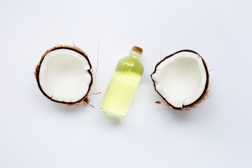 Coconut oil with coconuts on white