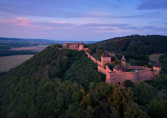 Helfstyn castle (German: Helfenstein, Helfstein), aerial view of a gothic castle in vibrant colors of setting sun, perched on high knoll above the Moravian Gate, Central Moravia, Czech Republic.