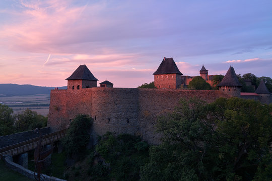 Helfstyn castle (German: Helfenstein, Helfstein), aerial view of a fortifications of gothic castle. Castle walls in vibrant colors of setting sun. Touristic destination, Central Moravia, Czechia.