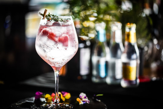 tonic gin with  fresh raspberry and rosemarie plant