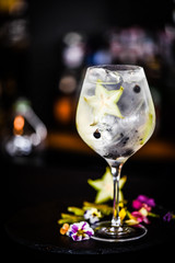 tonic gin cocktail with fresh carambola fruit