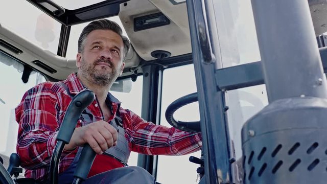 Farmer working on a modern tractor