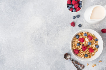 Healthy breakfast. Fresh granola, muesli with yogurt and berries on grey background. Copy space