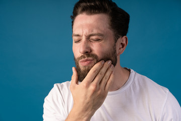 Man suffering tooth pain. Portrait of a handsome man. Concept- toothpain. Need some medical help.