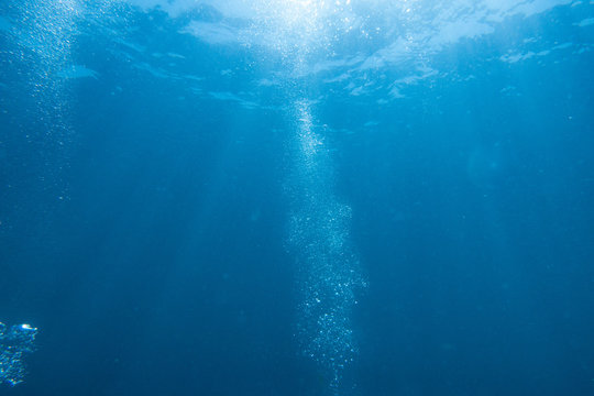 Scuba Diving bubbles with sun and rays.