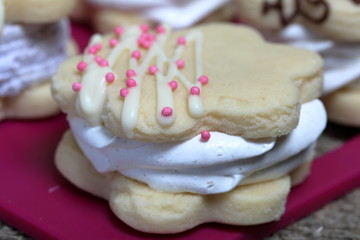 Marshmallow sandwich decorated with chocolate and decorative sprinkles. Set with decoration of different colors. Close-up shot.