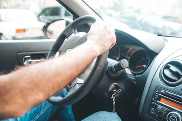 Mans hand and ignition key, car key for starting