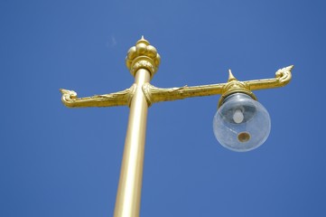 Fototapeta na wymiar gold lamp on blue sky