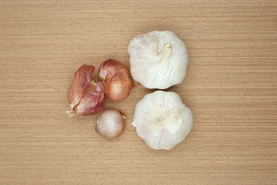 garlic and onion on wooden floor - Powered by Adobe