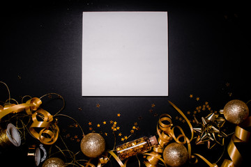 Notebook and Gift box with golden bow on black background with stars and sparkles. Festive  and wish list . New year resolution concept copyspace top horizontal view.
