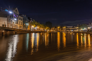 Fototapeta na wymiar Dutch city center with blurred reflections in water