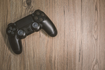 black joystick on a wooden table