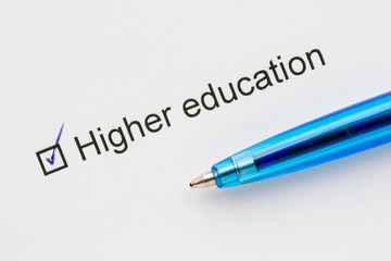 Higher education - check mark with pen on paper.