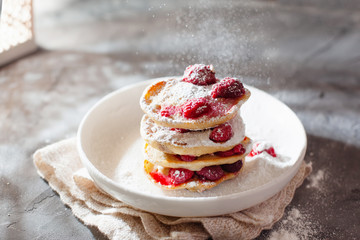 Pancakes with raspberry and sugar powder