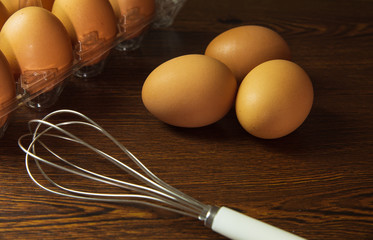 Fresh eggs prepared for cooking on wooden table
