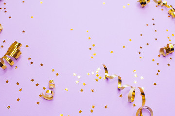 Golden decorations and sparkles on pale purple background