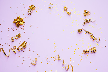 Golden decorations and sparkles on pale purple background