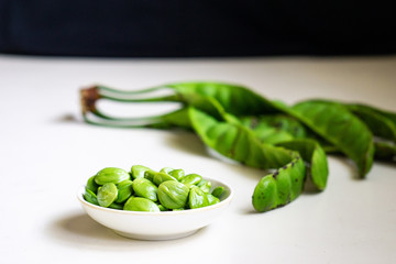 Raw bitter beans or Petai isolated on white background. Selective focus.