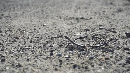 Lost sunglasses fall to the ground, two variants + hand retrieving the sunglasses, closeup, 4x slowmo