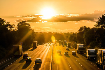 busy traffic on uk motorway road overhead view at sunset