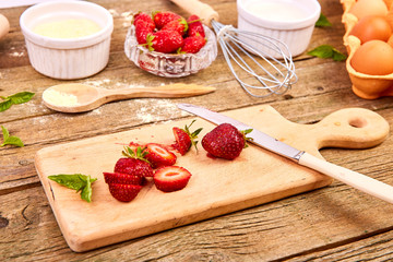 Strawberry on cutting board. Recipe for strawberry pie. Raw ingredients for cooking strawberry pie or cake on rustic background. Top view, flat lay. Copy space.