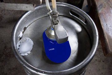 Beer keg or tank with blue label close up image. Mock up with copy space to add any text or use...